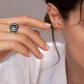 Enameled ring with an oval ruby and diamonds