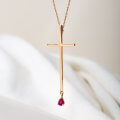 Cross necklace with a drop ruby