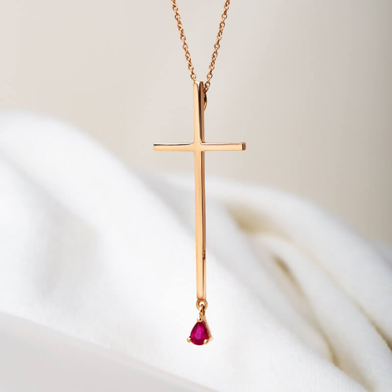 Cross necklace with a drop ruby